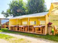 The tent with tables outside the hut