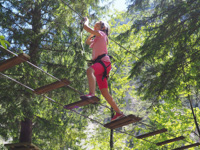 On the suspension bridge of the Acropark Roana