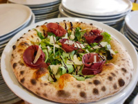 Pizza impasto napoli with bresaola salad parmesan flakes and balsamic vinegar