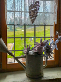 Floral decoration and wooden heart on the window