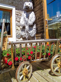 Bear carved into wood at the entrance to the Campolongo Refuge