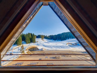 Window of the room overlooking the terrace and the ski slopes