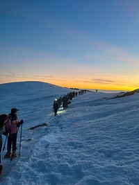 In the magic of the sunset with snowshoes