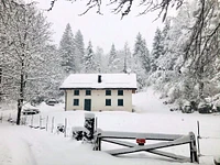 The Farmhouse in the Woods Wrapped in Snow