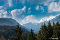 View snow-capped mountains surrounding the Asiago plateau